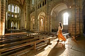France, Manche, the Mont-Saint-Michel, young woman in church interior's