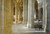 France, Manche, the Mont-Saint-Michel, young woman in church interior's and the Gothic choir