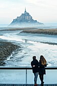 France, Manche, the Mont-Saint-Michel, view of the island and the abbey at sunrise from the mouth of the Couesnon river