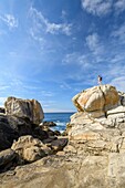 Frankreich, Finistere, Penmarch, Wanderer auf den Felsen von Saint-Guenolé