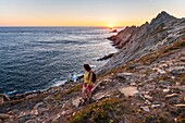 France, Finistere, Plogoff, hiker at sunset at Pointe du Raz