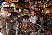 Yemen, Sana&#x2bd;a Governorate, Sanaa, Old City, listed as World Heritage by UNESCO, Souk Al Milh, man with a market stall