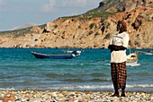 Yemen, Socotra Governorate, Socotra Island, listed as World Heritage by UNESCO, Qalansiyah, small fishing village, man praying on the beach