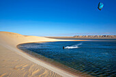 Morocco, Western Sahara, Dakhla, kitesurfer on the lagoon, between the White Dune and the desert mountains