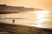 France, Somme, Bay of Somme, Picardy Coast, Ault, Walkers on beach at the foot of the cliffs