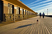 France, Calvados, Pays d'Auge, Deauville, the famous planks on the beach, lined with Art Deco style bathing cabins, each with the name of a celebrity who participated in the Deauville American Film Festival