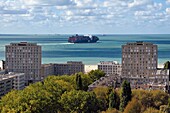 France, Seine Maritime, Le Havre, Downtown rebuilt by Auguste Perret listed as World Heritage by UNESCO, Perret buildings of Porte Océane (Ocean Gate) at the end of the Avenue Foch and a container ship in the background
