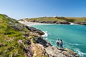 France, Morbihan, Belle-Ile island, Sauzon, couple in front of the Pointe des Poulains and the the lighthouse in background