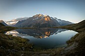 France, Hautes Alpes, The massive Grave of Oisans, Lake Pontet mirror of the Meije at sunrise