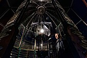 France, Gironde, Verdon sur Mer, rocky plateau of Cordouan, lighthouse of Cordouan, listed as World Heritage by UNESCO, portrait of lighthouse keepers in front of lighthouse lenticular system