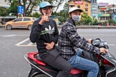 Vietnam, Red River Delta, Hanoi, young vietnamese on a scooter