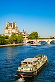 France, Paris, area listed as World Heritage by UNESCO, the banks of the Seine, an excursion boat with bicycles passes in front of the Louvre Museum
