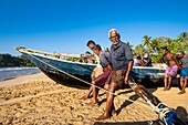 Sri Lanka, Southern province, Talalla beach, fishermen pulling up their fishingboat on the sand