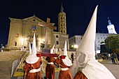 Spain, Aragon Region, Zaragoza Province, Zaragoza, Semana Santa (Holy Week) celebrations, San Juan de Los Panetes church in the background