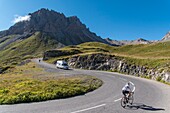 France, Savoie, Valloire, massif des Cerces, cycling ascension of the Col du Galibier, one of the routes of the largest bike domain in the world, camper and cyclists share the road in front of the Grand Galibier