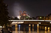 France, Paris (75), area listed as World Heritage by UNESCO, the banks of the Seine, the Ile de la Cité and Notre-Dame Cathedral during the fire of 15/04/2019