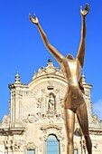 Italy, Basilicata, Matera, European Capital of Culture 2019, Piazza San Francesco, Baroque facade (18th century) of the Church of St. Francis of Assisi (San Francesco d'Assisi) with a sculpture of Salvador Dalí in the foreground