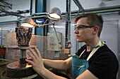 France, Bas Rhin, Wingen sur Moder, Lalique factory of Wingen on Moder, the cold hall, checking the perfect flatness of the foot of the vase, Lalique is a French luxury company, founded by the master glassmaker and French jewelery designer Rene Lalique in 1888