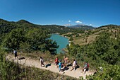 France, Isere, Trieves, Monteynard lake, group of hikers on the path of the footbridges