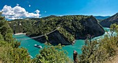 France, Isere, Trieves, Monteynard lake, hiking path bridges, panoramic view of the Ebron footbridge and the Mira boat
