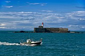 France, Herault, Agde, Cape of Agde, Fort of Brescou with a fishing boat in the foreground