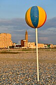 France, Seine Maritime, Le Havre, city rebuilt by Auguste Perret listed as World Heritage by UNESCO, pebble beach and its cabins with at the bottom the bell tower of the church of Saint Joseph