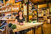 Canada, Nova Scotia, Cabot Trail, Cheticamp, Proud to be Lola's Hookers, hooked rug shop, major local craft, portrait of the proprietor, MR-CAN-18-04