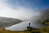 France, Hautes Alpes, massif of Oisans, National Park, Valgaudemar, Lake Lauzon and Sirac in the fog