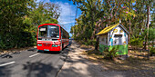 View of red bus and small shop in Cap Malheureux, Mauritius, Indian Ocean, Africa