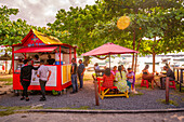 View of food stall in Grand Baie and boats in background, Grand Bay, Mauritius, Indian Ocean, Africa