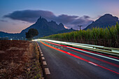 View of trail lights and Long Mountains at dusk near Beau Bois, Mauritius, Indian Ocean, Africa