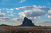 Usa, New Mexico, Shiprock, Clouds over desert landscape with Shiprock