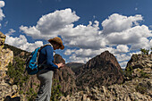 USA, Colorado, Creede, Woman looking at smart phone on trial in San Juan Mountains