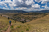USA, Colorado, Creede, Rear view of woman hiking near town