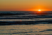 Sun setting over ocean at Cannon Beach