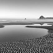 USA, Oregon, Shallow pools of water at Cannon Beach