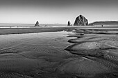 USA, Oregon, Sand, flache Wassertümpel und Felsformationen am Cannon Beach