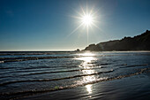 USA, Oregon, Newport, Sun sets over beach 
