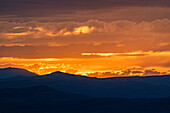 Beautiful sunset over silhouettes of mountains 