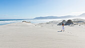 Teenage girl (16-17) exploring beach in Walker Bay Nature Reserve