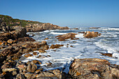 South Africa, Hermanus, Rocky coastline and sea at Kammabaai Beach