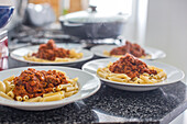 Dishes of homemade macaroni with bolognese sauce