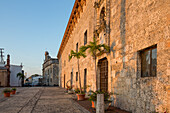 Former Palace of the Governors with the National Pantheon behind in the old Colonial City of Santo Domingo, Dominican Republic. The Palace is now Las Casas Reales Museum. The National Pantheon was formerly a Jesuit church. UNESCO World Heritage Site of the Colonial City of Santo Domingo.