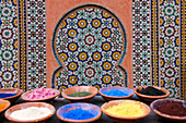 Marrakech, Morocco. Clay bowls of spices and bluing with tile background.