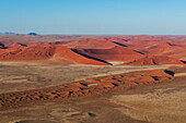 An aerial view of red sand dunes in the Namib desert. Namib Naukluft Park, Namibia.