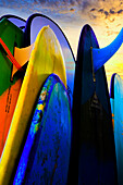 Stacked surf boards at sunset after a day of surf school in Canggu, Bali, Indonesia