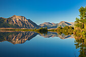 Canada, Alberta, Waterton Lakes National Park. Canadian Rocky Mountains reflected in Lower Waterton Lake.