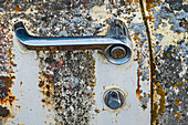 Canada, Manitoba, St. Lupicin. Close-up of rusted paint patterns and handle on vintage car.