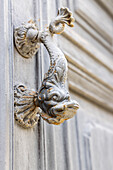 Aigues-Mortes, Gard, Occitania, France. Old door knocker in the shape of a fish.
