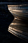 Ireland. Boat reflection on Lake Cummeenduff.